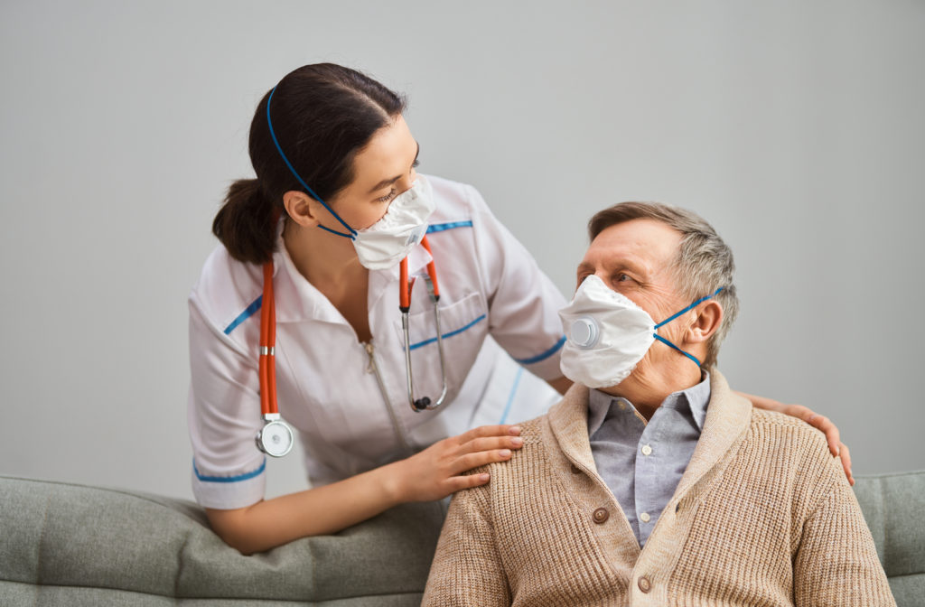 Senior man meets doctor to discuss his options for vaccine. 