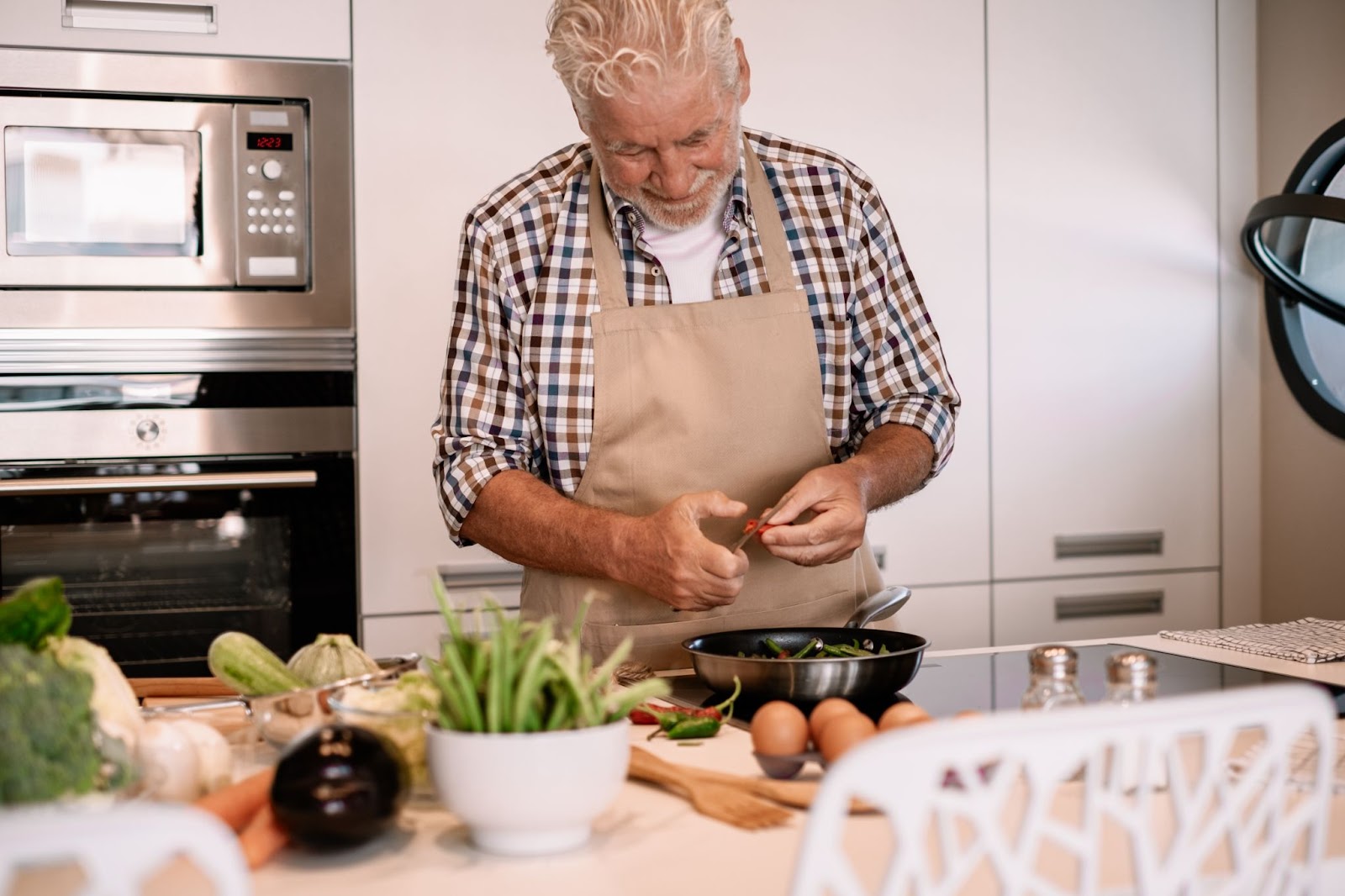 An older man is meal prepping his ingredients to make easy meals throughout the week.