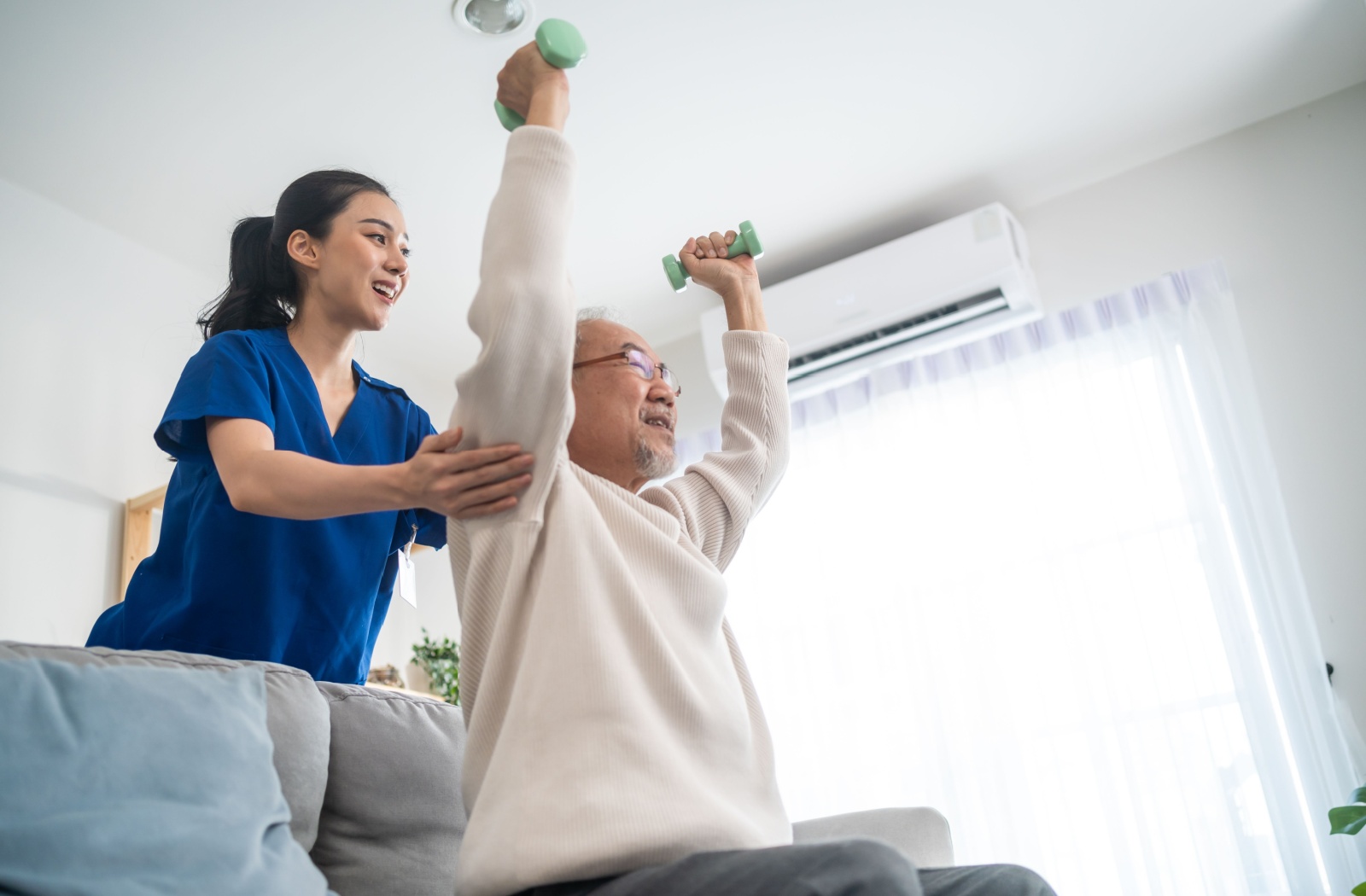 An occupational therapist assists a senior in building shoulder strength to enhance their mobility.