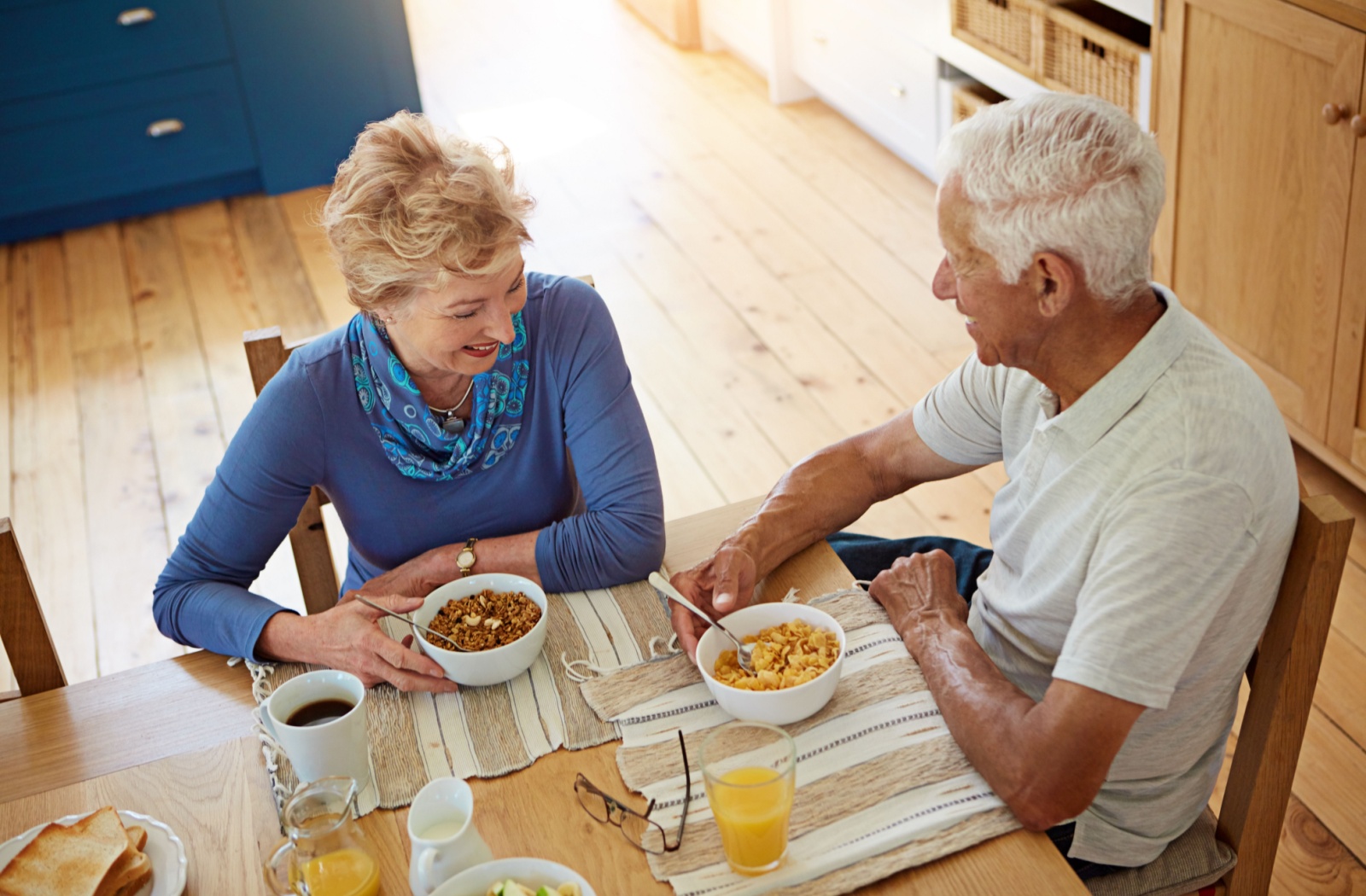 A senior couple enjoys each other’s company over a nutritious breakfast as part of the start of a good day.